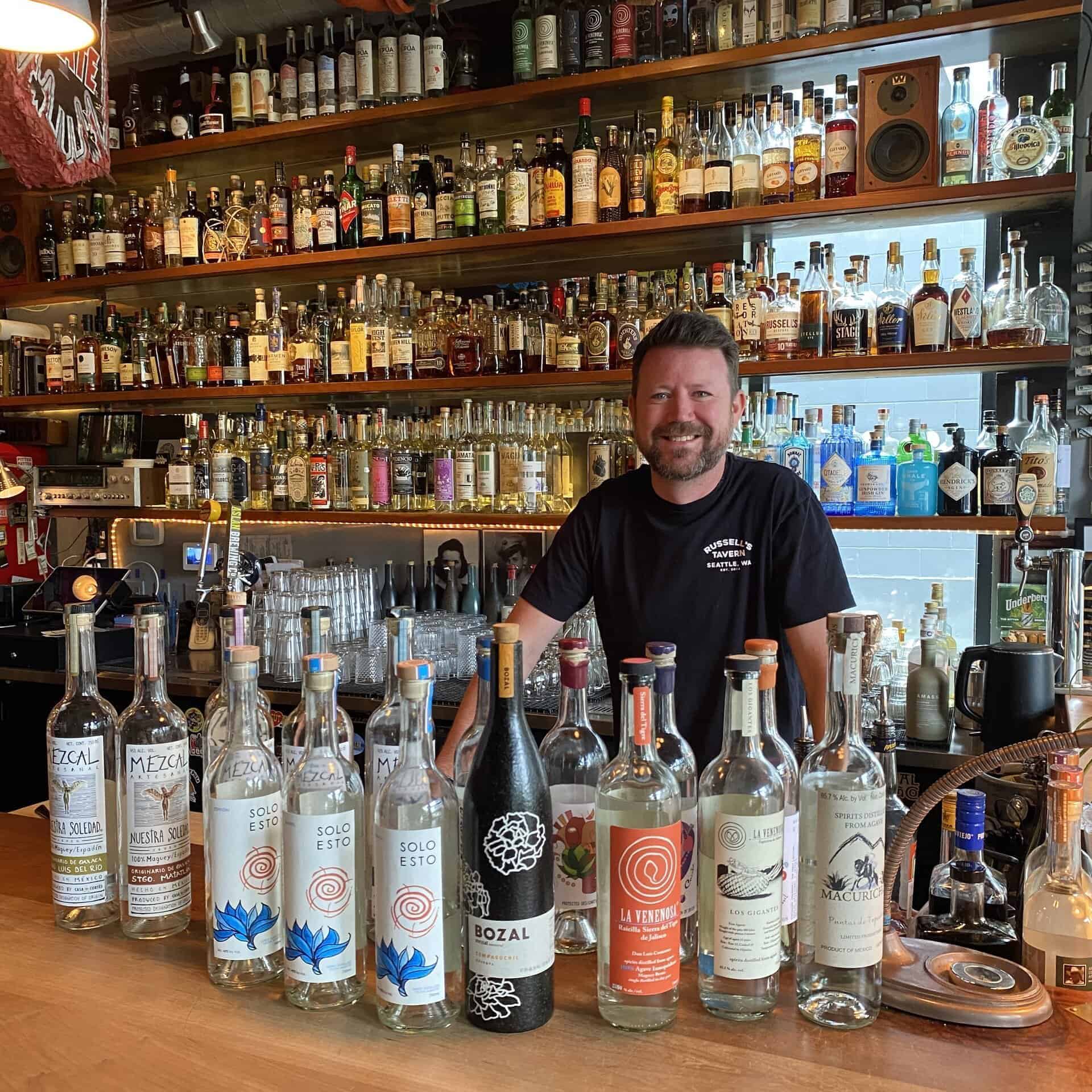 Joe Russel behind the bar, serving up a fine selection of mezcal in Seattle