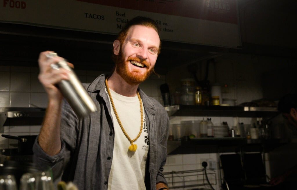 A picture of Jon Darby mixing a mezcal cocktail at his London mezcal bar
