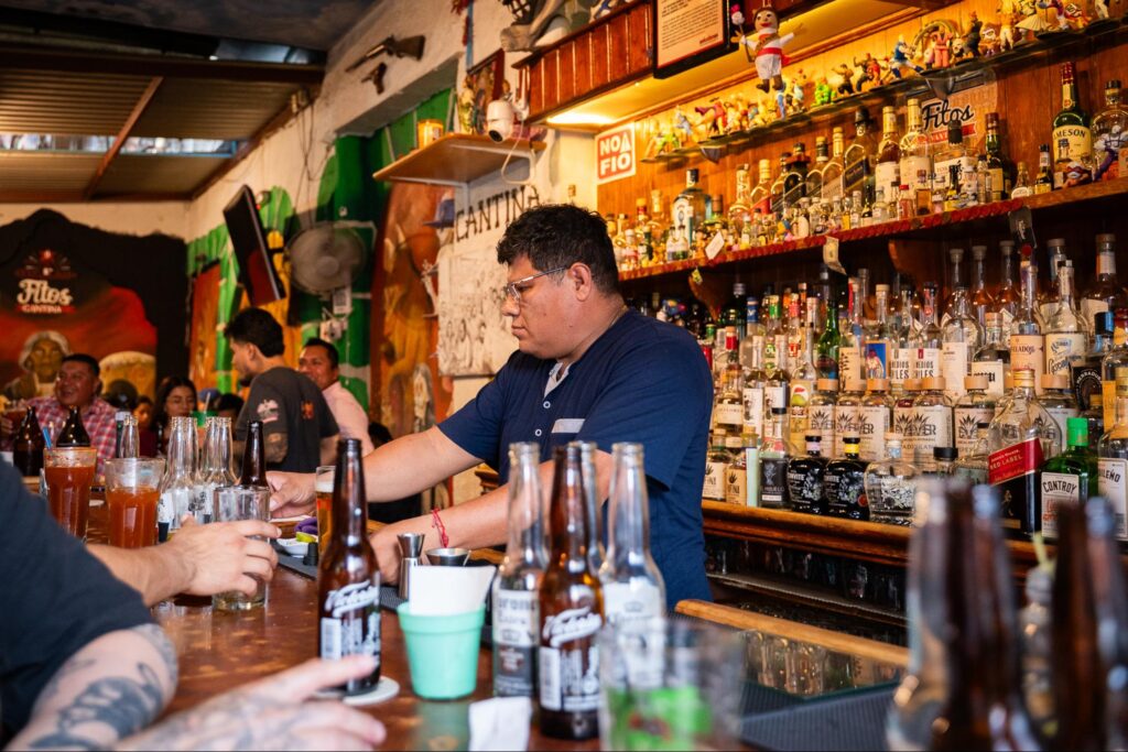 A man behind the bar in a Oaxacan mezcal bar